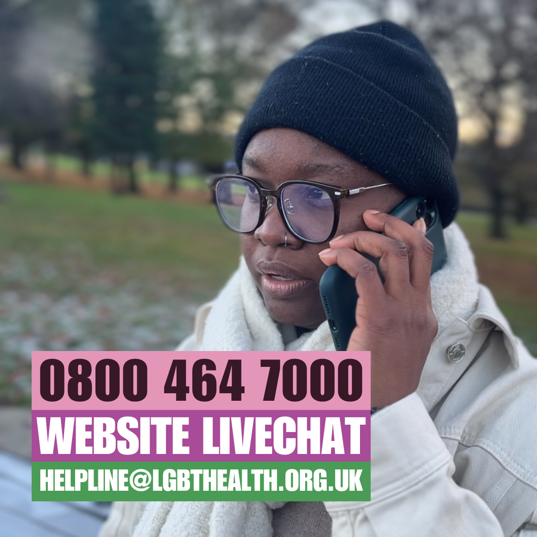 A community member outside in a park phoning the helpline.