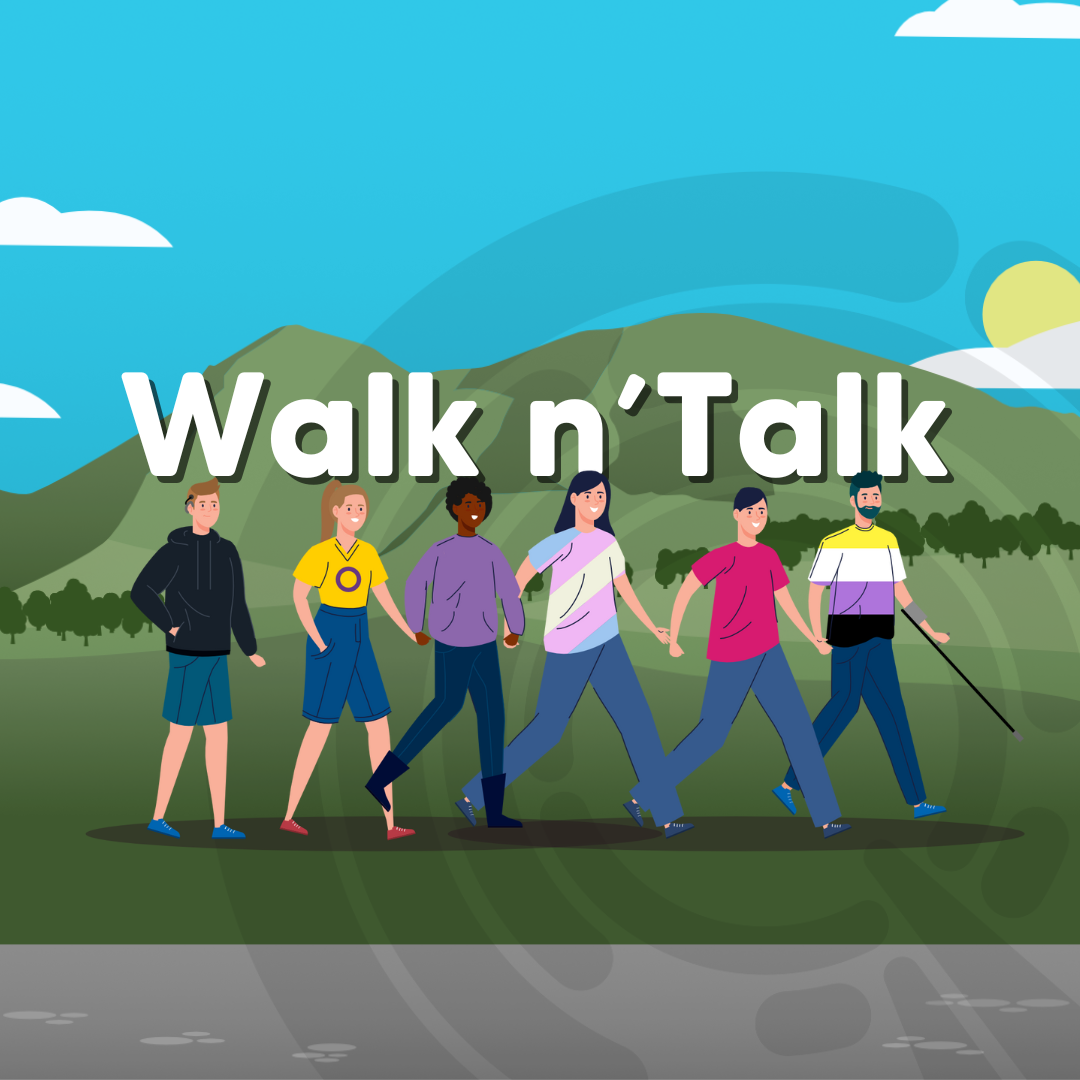 A diverse group of people with t-shirts in different LGBT flags walking with Arthur Seat in the background