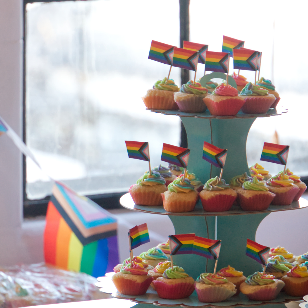 A tower of cupcakes with little Pride flags on them
