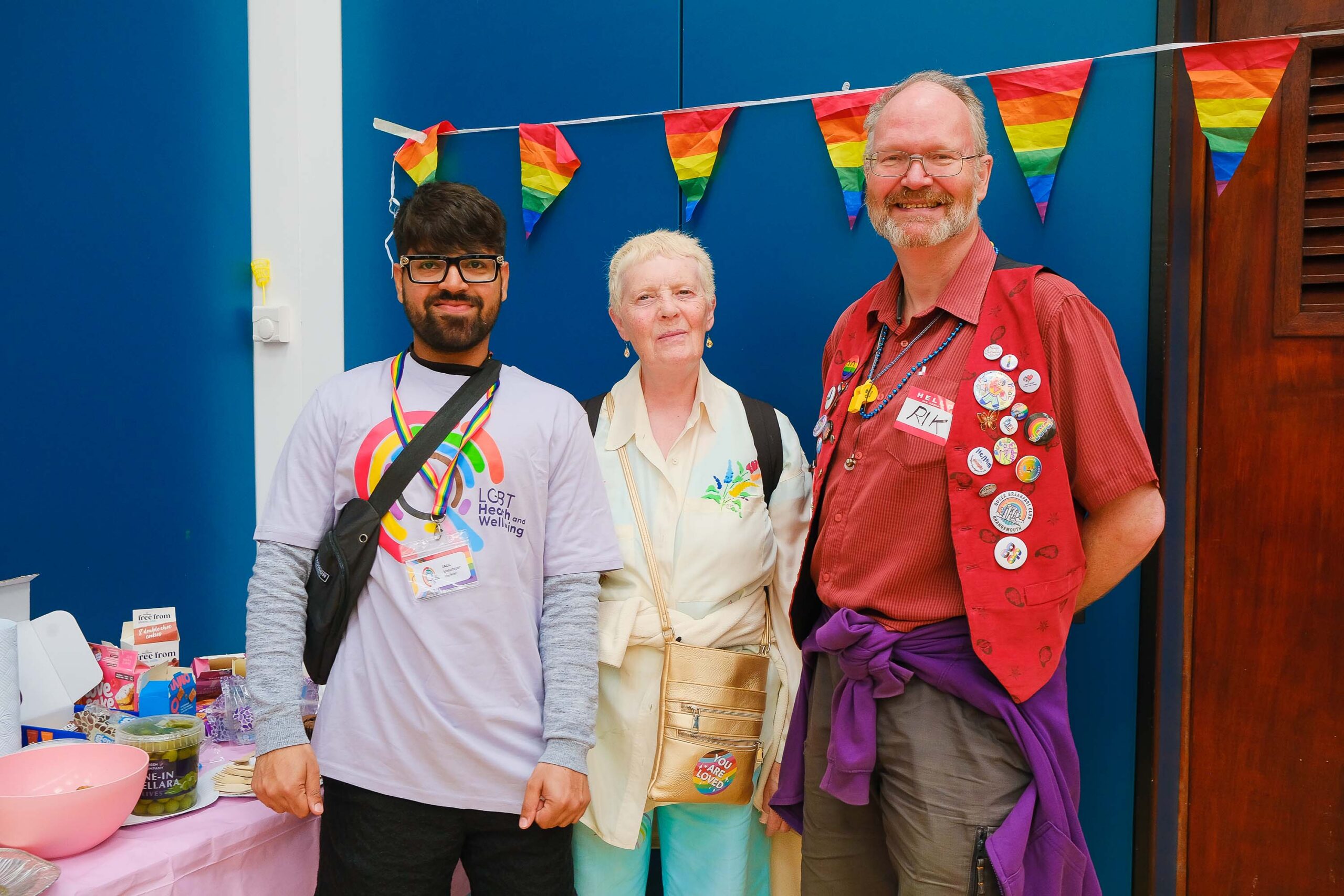 A LGBT Health and Wellbeing volunteer with two community members at our Pride Breakfast event