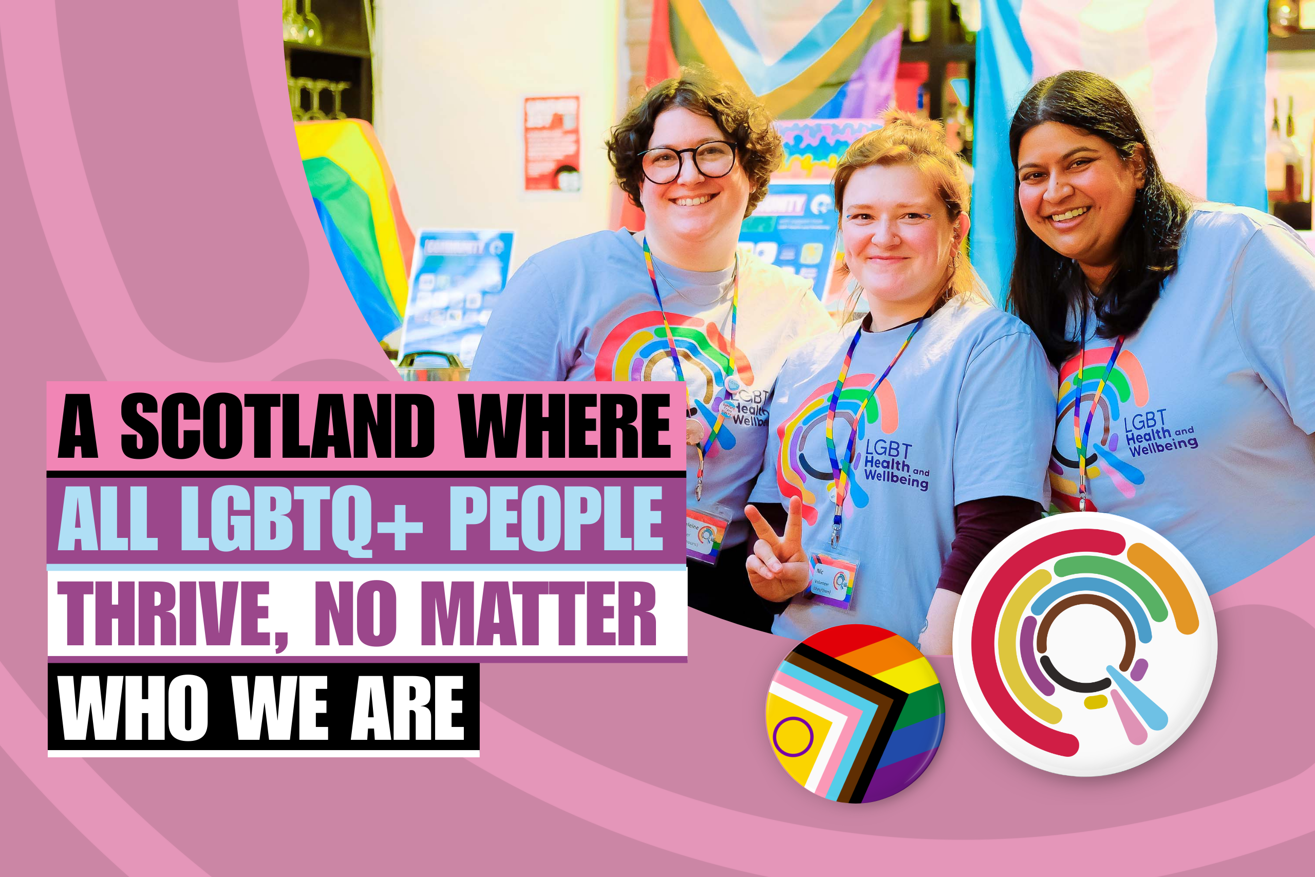 Three LGBT Health and Wellbeing volunteers at an event wearing logo T-shirts with text "A Scotland where all LGBTQ+ people thrive, no matter who we are".