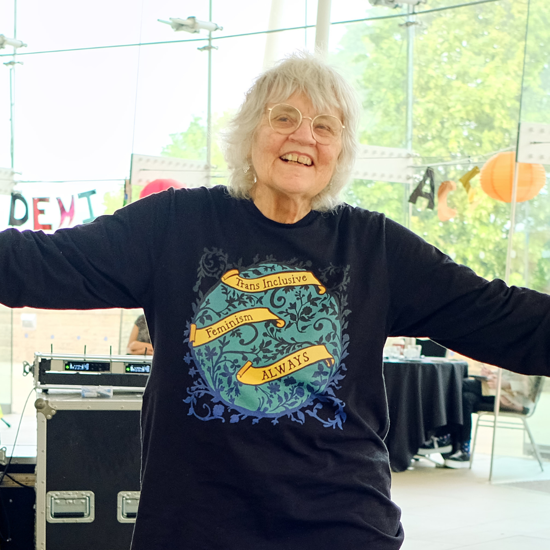 An older community member at our Pride Breakfast wearing a sweater with text 'Trans inclusive feminism always'