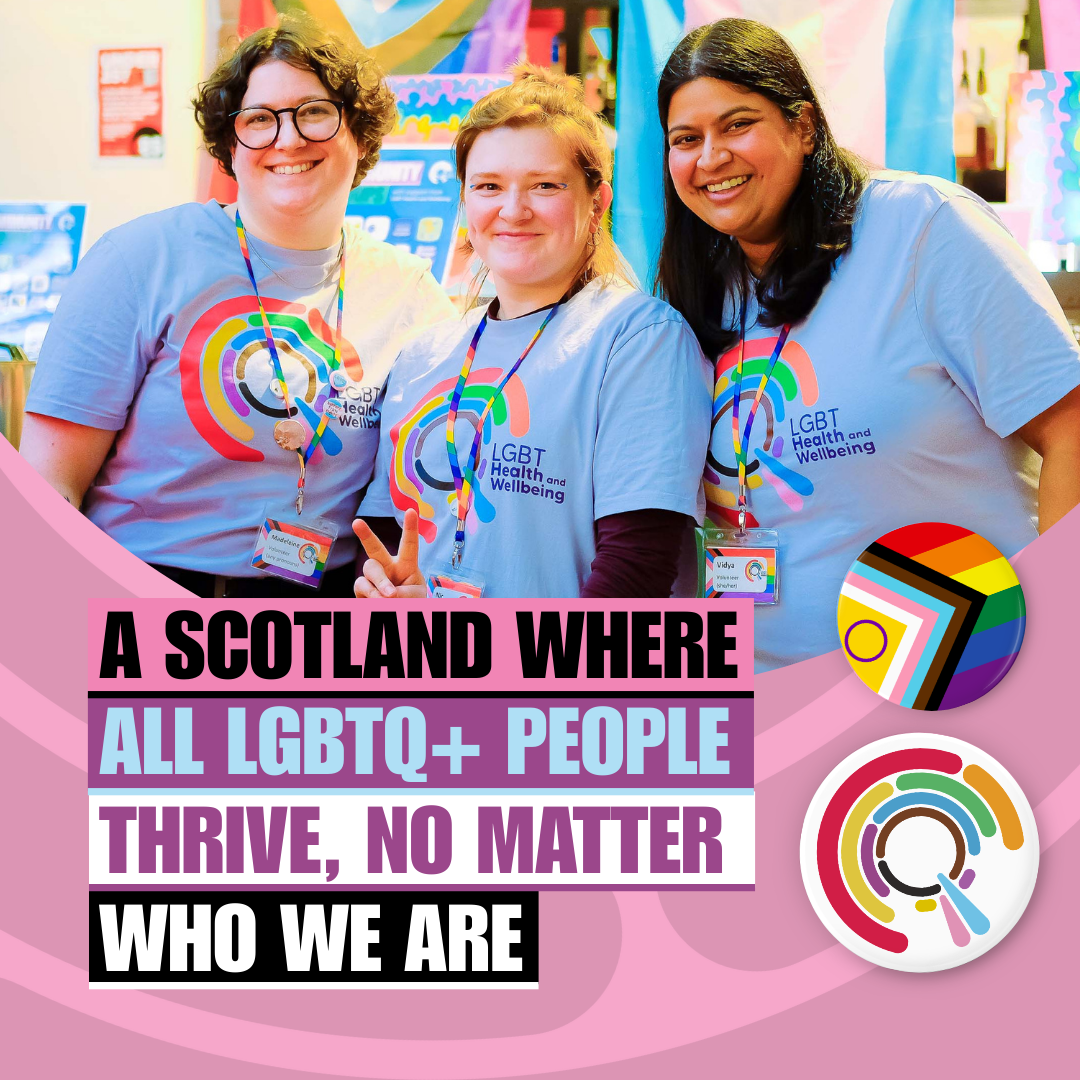 Three LGBT Health and Wellbeing volunteers at an event wearing logo T-shirts with text "A Scotland where all LGBTQ+ people thrive, no matter who we are".